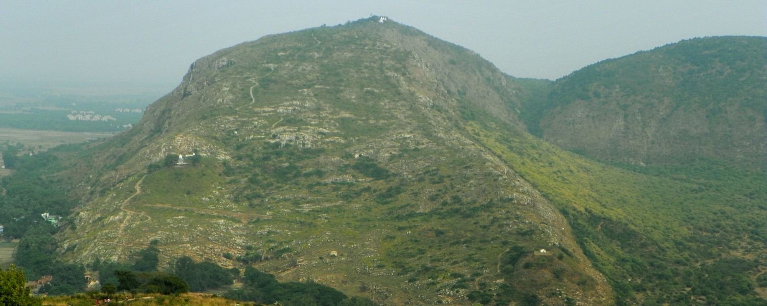 Captivating aerial view of lush Rajgir Hills surrounded by picturesque landscape and ancient ruins