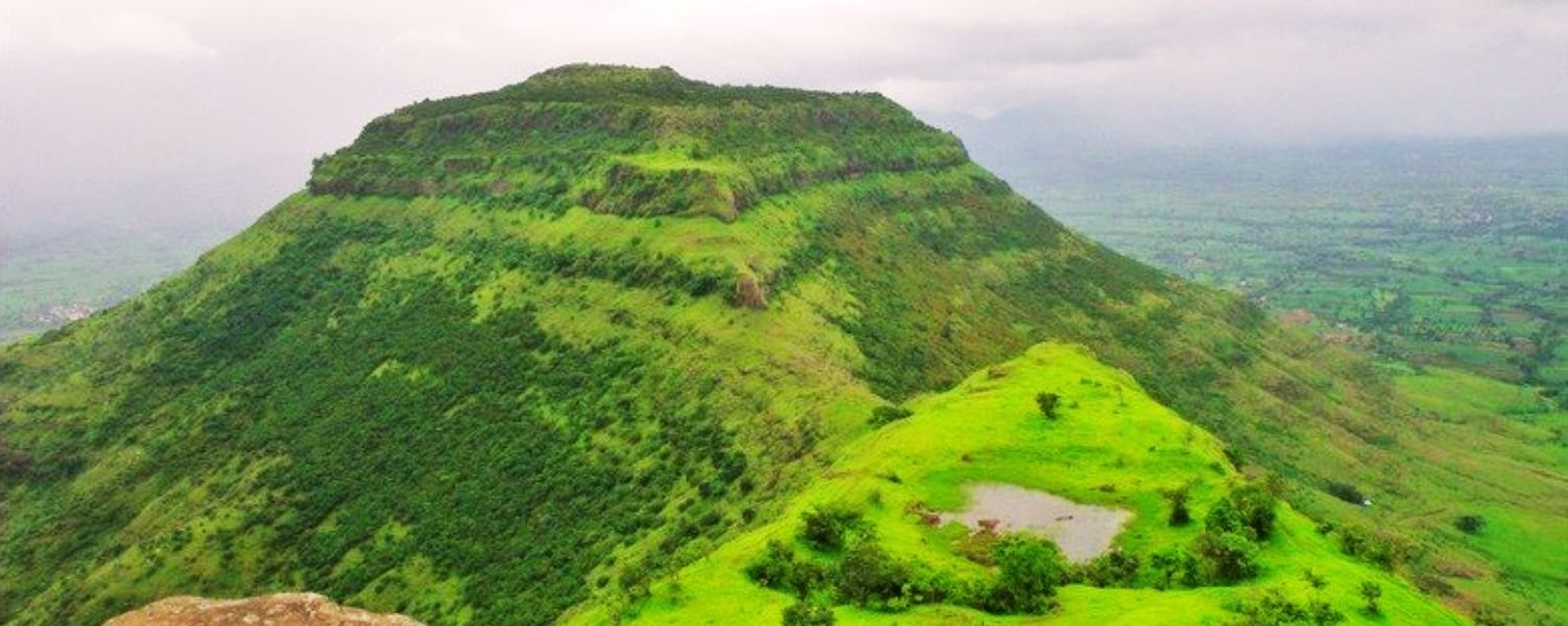 Enchanting view of Chandan Hills, with lush green landscapes and a vibrant sunset sky