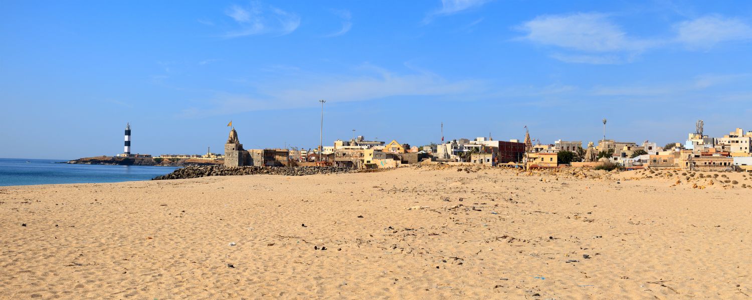 Scenic Beyt Dwarka Beach with turquoise waters and sandy shoreline.